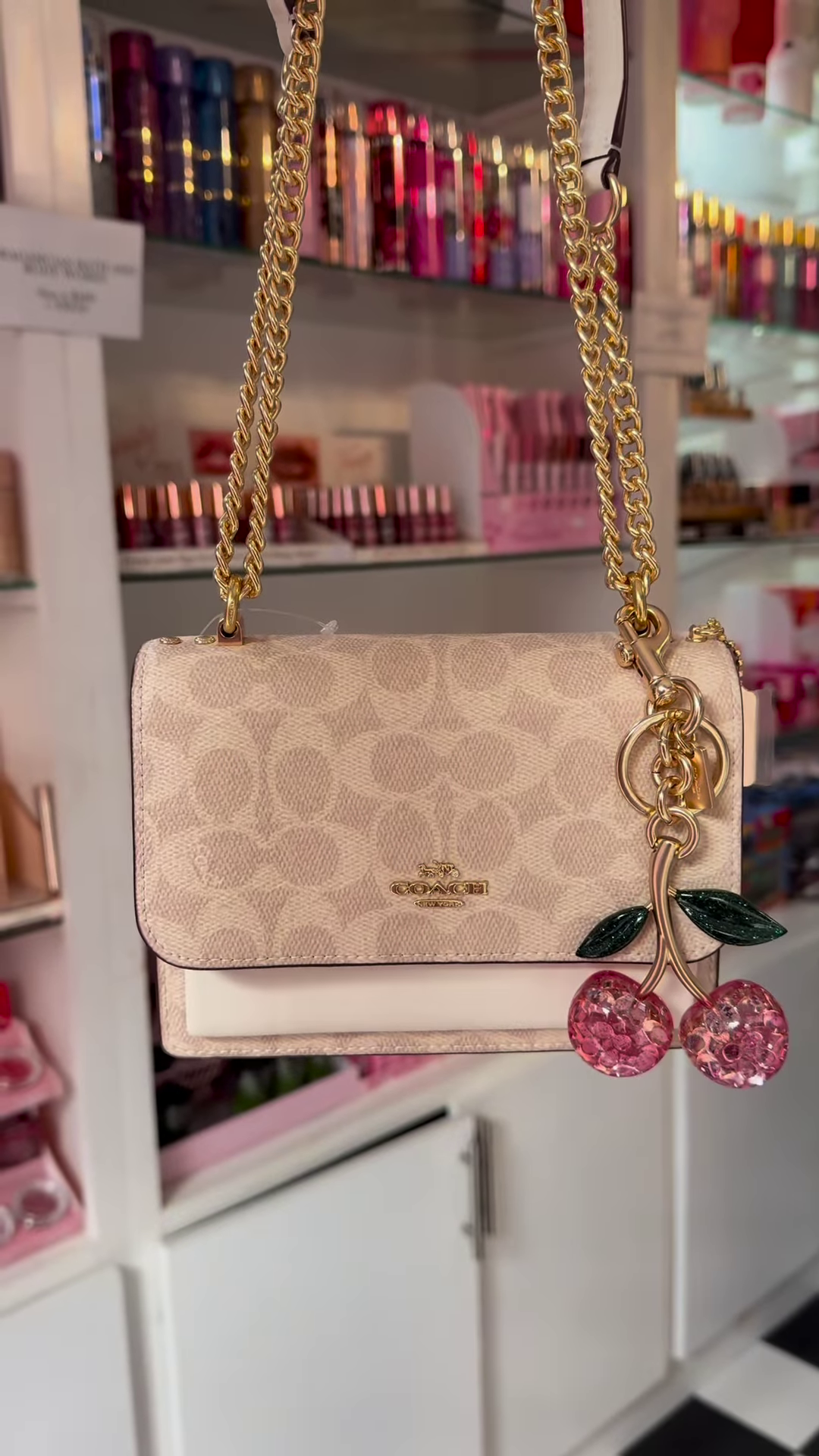 Elegant Designer Crossbody Bag with Signature Pattern and Chain Strap