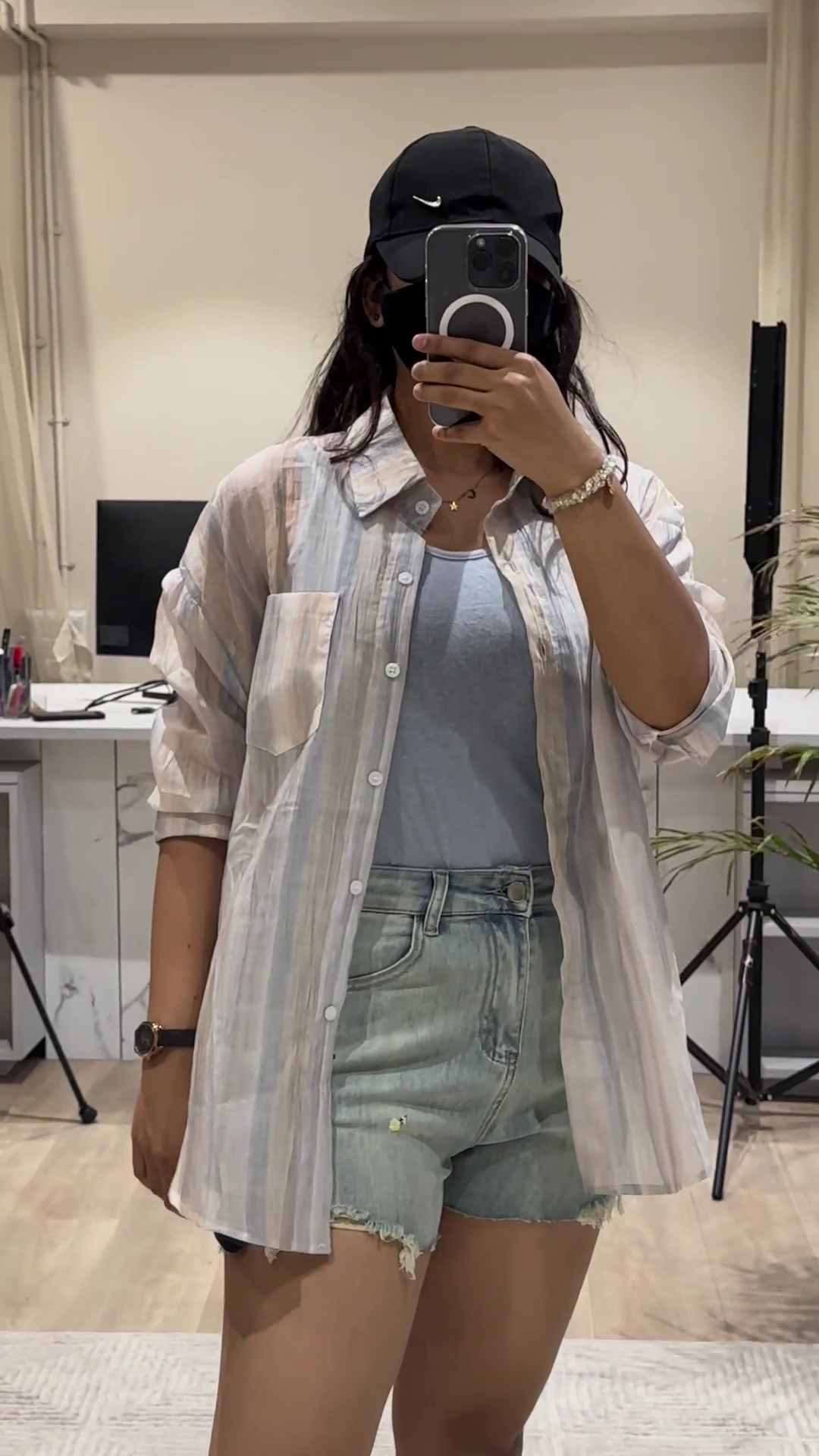 Casual Layered Outfit: Pink Button-Down Shirt, Tank Top, and Denim Shorts - Image 2