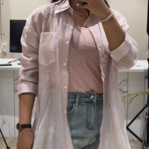Casual Layered Outfit: Pink Button-Down Shirt, Tank Top, and Denim Shorts