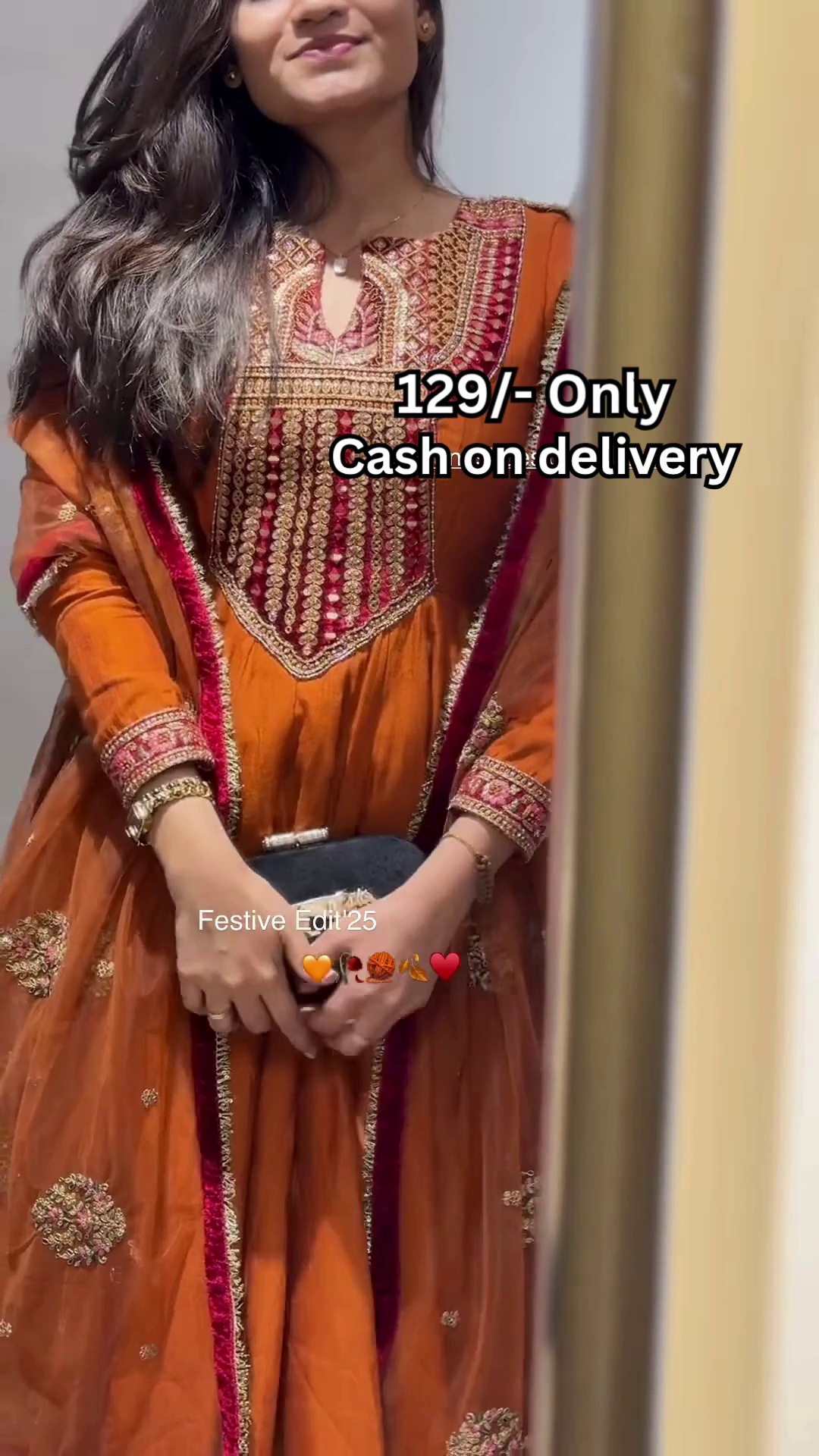 Women’s Orange Embroidered Kurti with Gold & Red Threadwork – Festive Ethnicwear Styled with Black Clutch Accessory