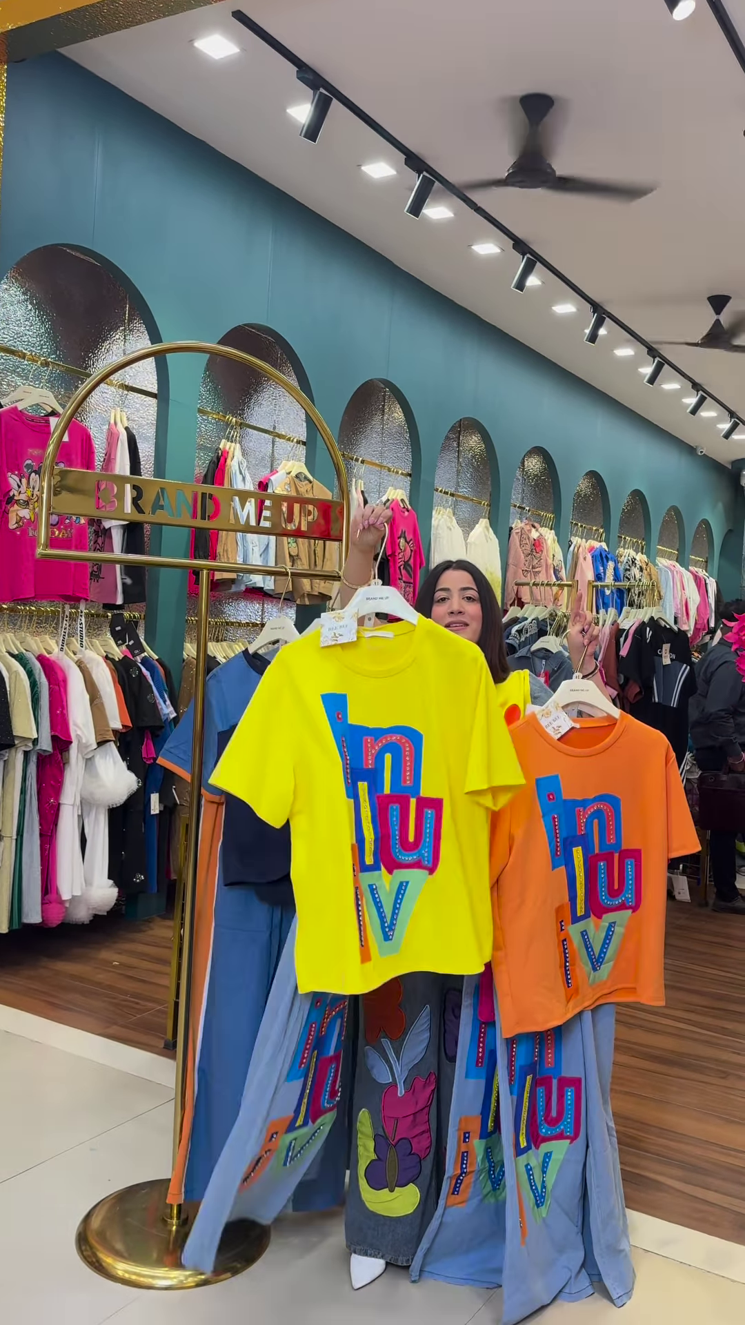 Multicolor Printed Ethnicwear Rack Display – Bold Floral & Abstract Garments in Boutique Interior with Teal-Gold Accents - Image 3